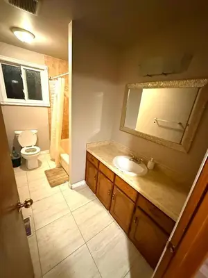 a bathroom with a sink and a toilet and a mirror at LONG WEEKEND BUMPER OFFER- Transit,Airport,Downtown Minutes Drive in Kitchener