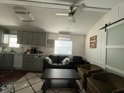 a living room with a couch and a table at Sherkton Shore Resort in Port Colborne