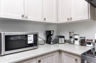 a kitchen counter with a microwave and appliances on it at Modern Home 10 mins from Niagara Falls & Main Attraction with Free 2 Parkings in Thorold