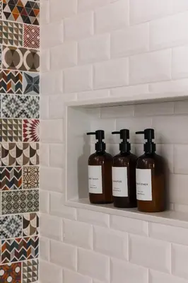 three bottles of soap sitting on a shelf in a bathroom at SquirrelHaus PEC in Hillier