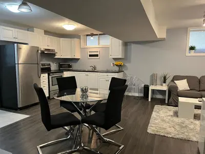 a kitchen and living room with a table and chairs at Just like home 1 bedroom appt in Guelph
