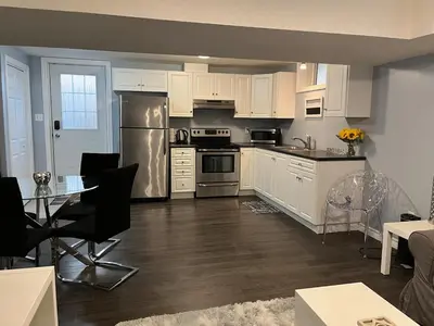 a kitchen with white cabinets and stainless steel appliances at Just like home 1 bedroom appt in Guelph