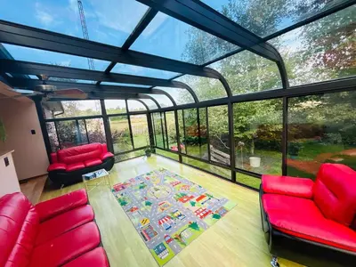 a living room with red furniture and a large window at Charming Farmhouse in Grafton