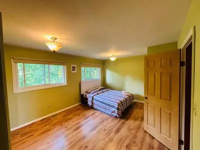 a bedroom with a bed and a window and a door at Charming Farmhouse in Grafton