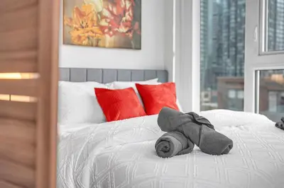a stuffed animal is laying on a bed at Luxe 5bd Unit sleeps 11 - Hospitals MTCC TTC ACC in Toronto