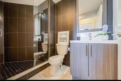 a bathroom with a toilet and a shower and a sink at Condo at Yonge-Sheppard Station, North York in Toronto
