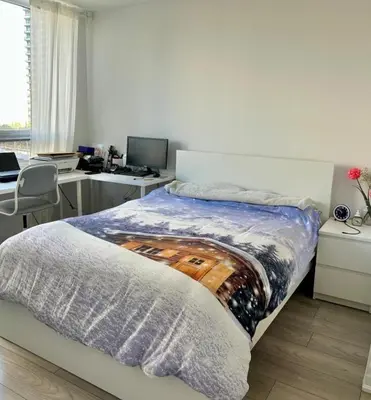 a bedroom with a bed and a desk with a computer at Modern & Stylish Condo Downtown in Mississauga