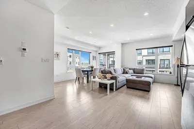 a living room with a couch and a table at Ritzy 3BR Home with Balcony Near Burlington Pier in Burlington