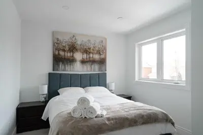 a bedroom with a bed with two towels on it at Luxury 2 Bedroom 3 Bed Family Friendly Oasis with Smart Technology in Brampton
