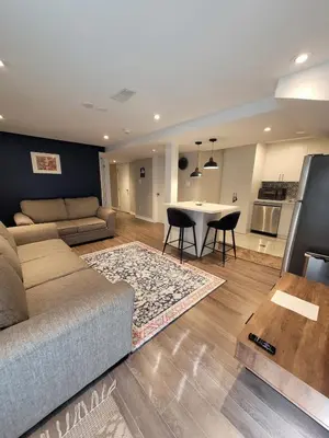 a living room with a couch and a table at Cozy 2 Bed Rooms Apartment in Prime Location! in Mississauga