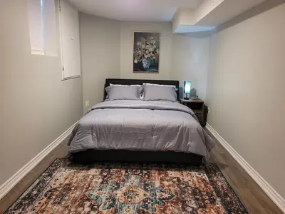 a bedroom with a bed and a rug at Cozy 2 Bed Rooms Apartment in Prime Location! in Mississauga
