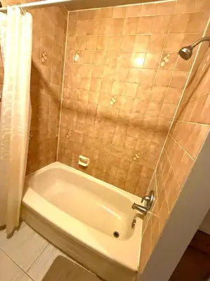 a bathroom with a bath tub and a shower at YKF Airport Home-FREE FAST WIFI-FREE PARKING in Hespeler