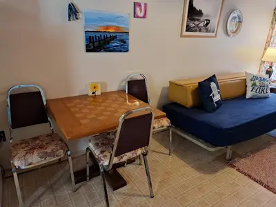 a room with a bed and a table and chairs at Wymbolwood Lodge in Tiny