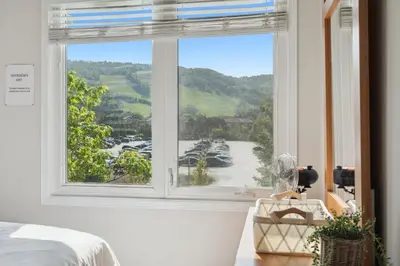 a bedroom with a window with a view of a harbor at Wintergreen Spacious 2 Story Townhome Sauna 2 Min Walk to Village in Blue Mountains