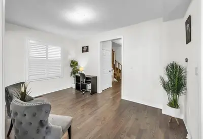an empty living room with a chair and a desk at Modern Comfort in Clarington in Newcastle