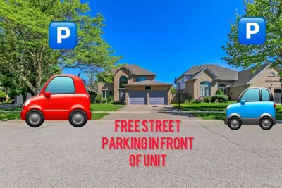 two cars parked in a driveway in front of a house at Luxury & private 3 bed basement unit kitchen, wifi, park, mall in London