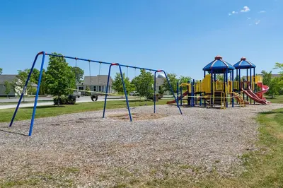 a park with a playground with a slide at The Mayflower - 4 Pine Forest in Cherry Valley