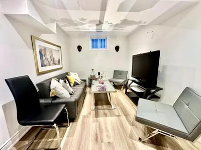 a living room with a couch and a tv at Comfortable place In An Amazing Location in Toronto