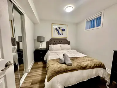 a bedroom with a bed with two towels on it at Comfortable place In An Amazing Location in Toronto