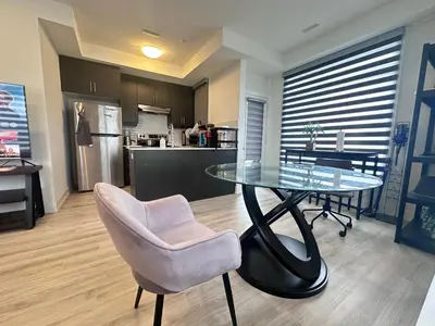 a glass table and a chair in a kitchen at 2bedroom Townhome in South Richmond Hill in Richmond Hill