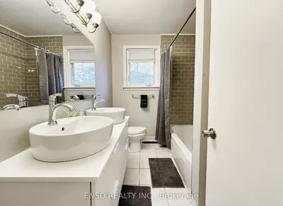 a white bathroom with a sink and a toilet at Canada WonderLand Stay-Superb Location in Vaughan