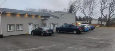 a truck parked in a parking lot next to a building at Sartawi Place -Studio at Georgian Bay in Waubaushene