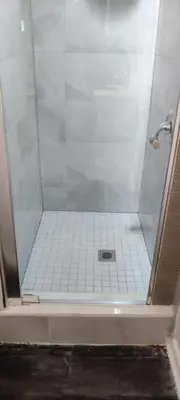a shower with a glass door in a bathroom at Sartawi Place -Studio at Georgian Bay in Waubaushene