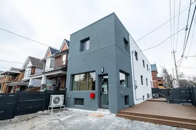 a house is being constructed with a fence at Adorable Modern Master Bedroom near Colleges and K-town in Toronto