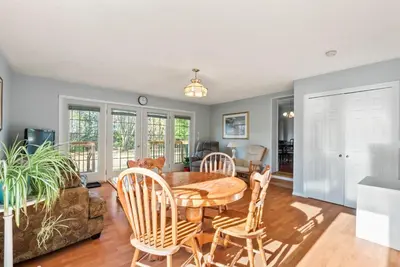 a kitchen and living room with a table and chairs at Spacious Beach Town Retreat - Sleeps 8 in Port Elgin