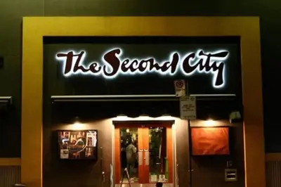 a sign for the second city on the front of a store at Chic 1BR Condo Lake and City Views plus Free Parking in Toronto