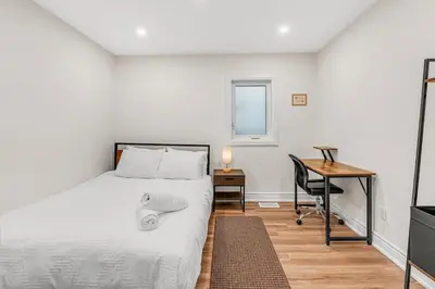 a bedroom with a bed and a desk and a desk at Cozy 2BR Home with Workspace Toronto Retreat in Toronto