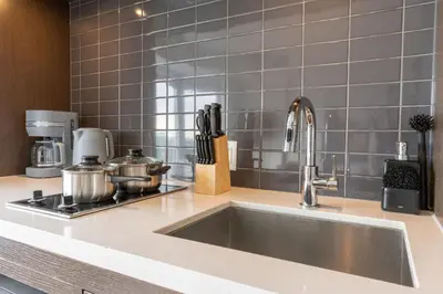 a kitchen counter with a sink in a kitchen at Chic 1BR plus Den Condo Near ROM and CN Tower in Toronto