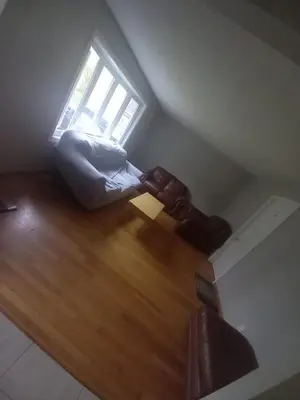 a living room with a couch and a window at Homestay Near Victoria Park- FREE WIFI & PARKING-TOP LOCATION in Kitchener