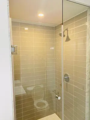 a bathroom with a shower with a glass door at The Residence, Your comfort is our culture in Oakville