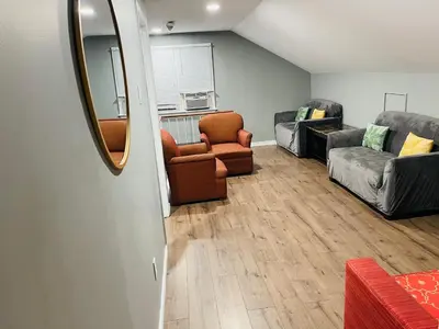 a living room with couches and chairs and a mirror at Holiday Home 7865LL in Niagara Falls