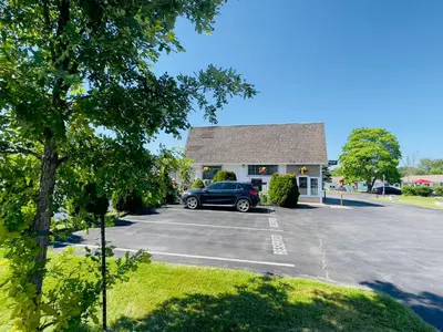 a car parked in a parking lot in front of a building at Holiday Home 7865LL in Niagara Falls