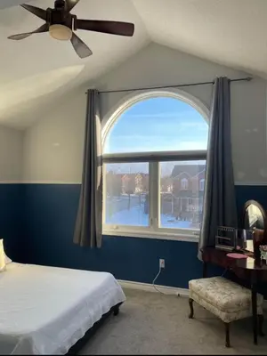 a bedroom with a bed and a large window at Serene Bedroom with Private Ensuite in Georgina