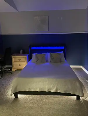 a bed with a blue headboard in a bedroom at Serene Bedroom with Private Ensuite in Georgina