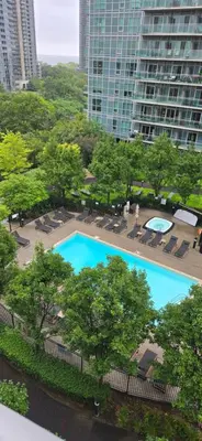 an overhead view of a swimming pool with chairs and trees at Lovely condo near Lake Ontario in Toronto