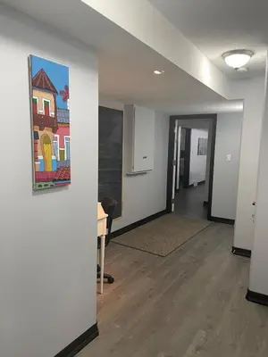 a room with a painting on the wall and a table at Entire Apartment in Guelph