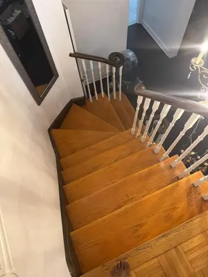 a wooden spiral staircase in a house at Pearson Gateway Comfort Home in Mississauga