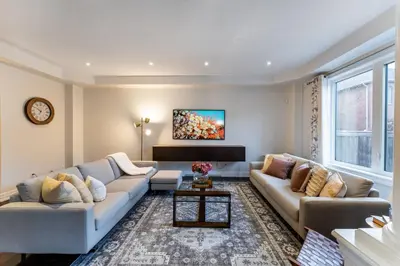 a living room with two couches and a tv at Family Retreat. in Milton