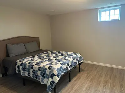 a bedroom with a bed in a room with a window at A getaway in Niagara from hustle bustle in Welland