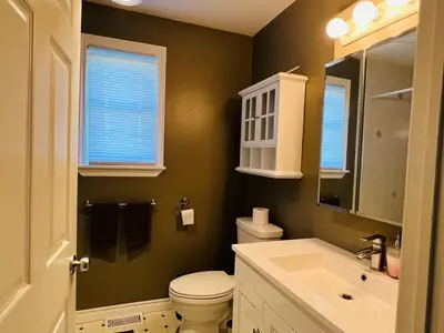 a bathroom with a white toilet and a sink at A getaway in Niagara from hustle bustle in Welland