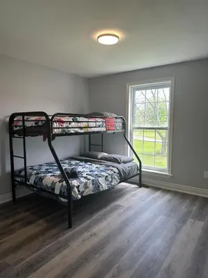 a bedroom with bunk beds in a room with a window at A getaway in Niagara from hustle bustle in Welland