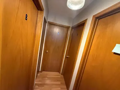a hallway with wooden doors and a light on the ceiling at Homestay at Heart Of Kitchener-Free Wifi & Parking in Kitchener