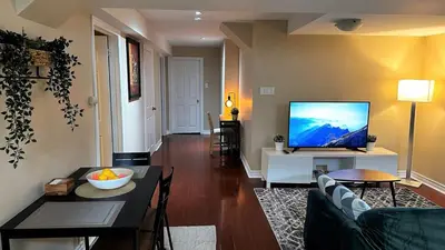 a living room with a couch and a flat screen tv at 2 Bed-2Bath-Kitchen Private Family Couple Work in Newmarket