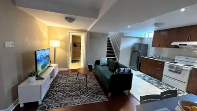 a living room with a couch and a kitchen at 2 Bed-2Bath-Kitchen Private Family Couple Work in Newmarket