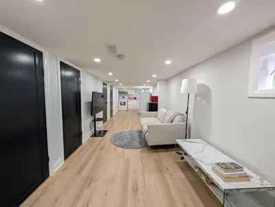 a living room with a couch and a table at The Urban Hideaway - Stylish Stay - Prime Spot in Hamilton