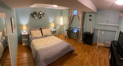 a bedroom with a bed and a desk in it at Country Roads Dwelling in Hamilton